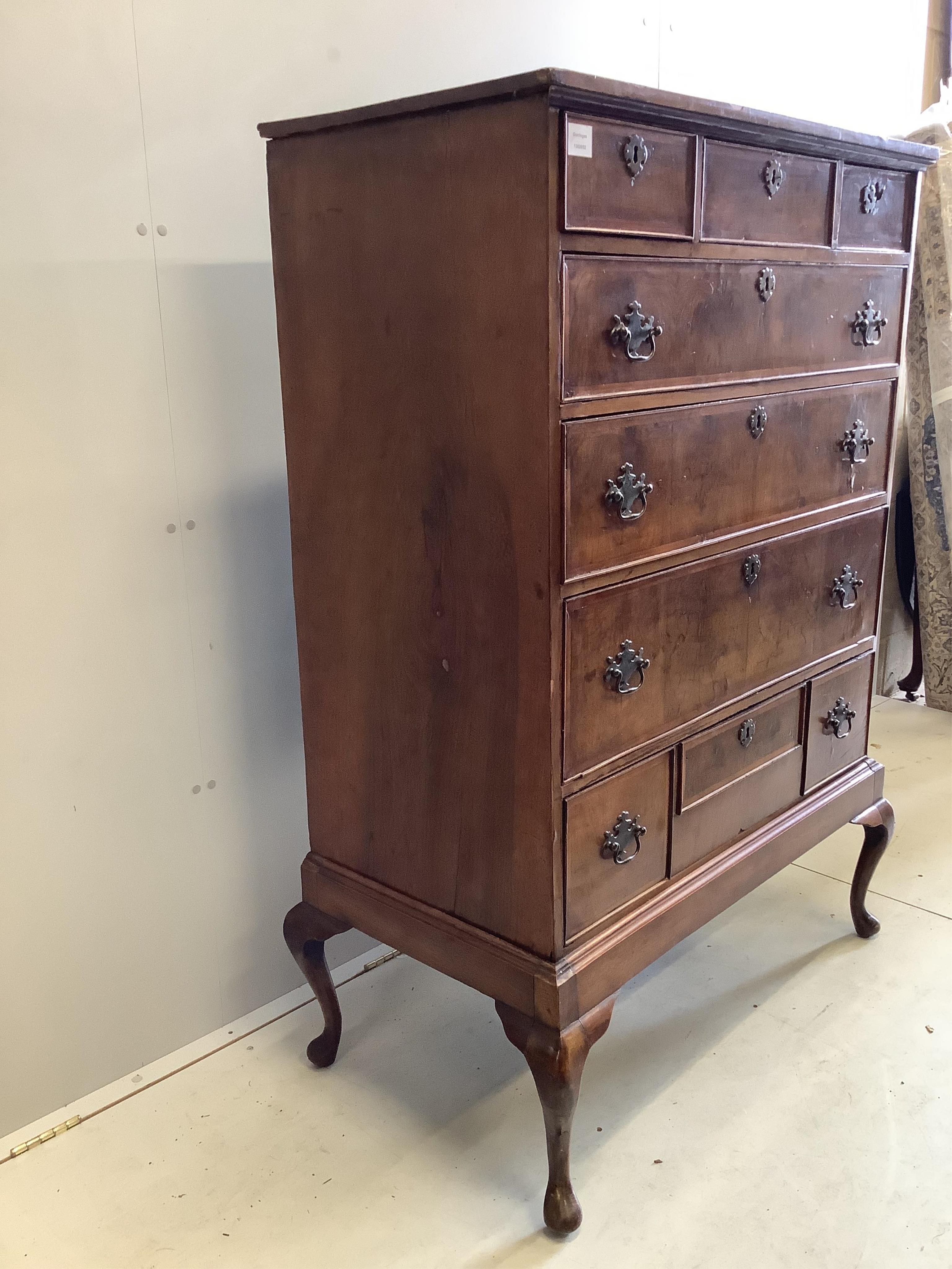 An 18th century and later feather-banded walnut chest on stand, width 96cm, depth 51cm, height 144cm